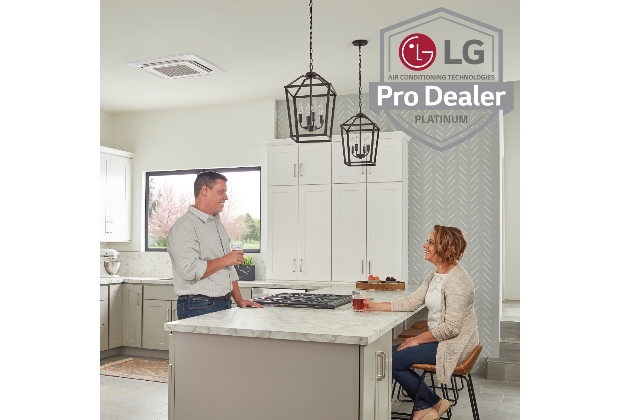 Couple in their kitchen talking, LG Pro Dealer Logo in the background