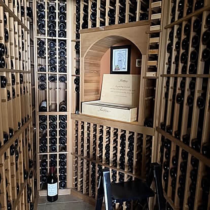 Custom timber wine racking surrounding an arched display niche