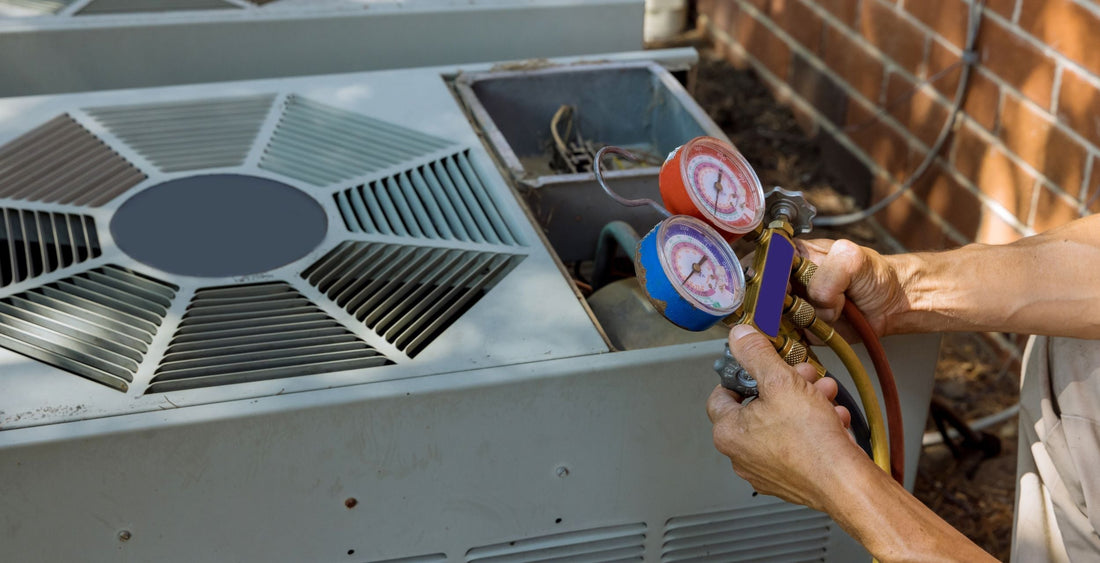 A HVAC Tech working on an outdoor condenser. 