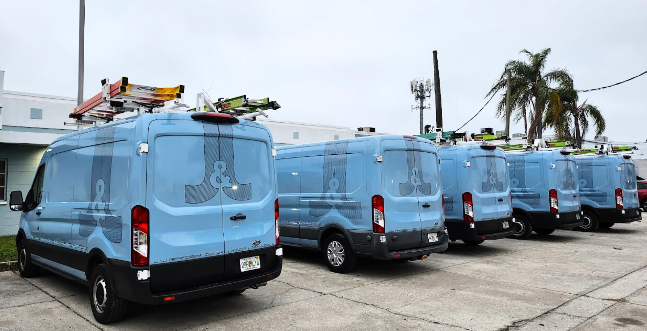 J&J Refrigeration Inc. trucks lined up infront of the building